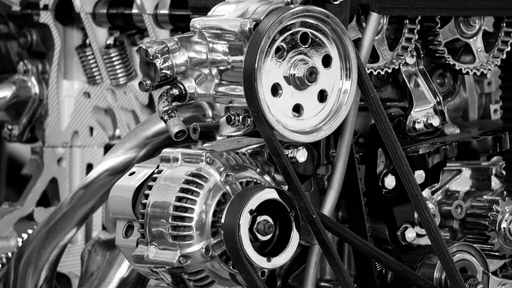 pexels photo 190574 190574 Close-up of a shiny car engine showing polished metal parts and gears in black and white.
